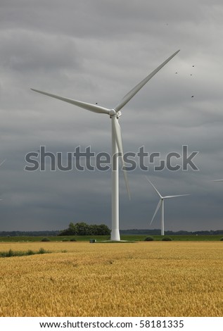 A windmill-powered plant in front of a dark and cloudy sky