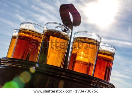 Similar – Image, Stock Photo A fresh beer (Kölsch) is tapped at the tap in a bar