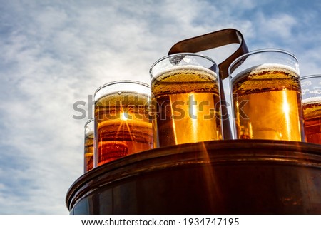 Similar – Image, Stock Photo A fresh beer (Kölsch) is tapped at the tap in a bar