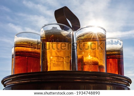 Similar – Image, Stock Photo A fresh beer (Kölsch) is tapped at the tap in a bar