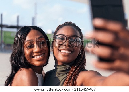 Similar – Image, Stock Photo Black woman taking photo of friends having piggyback ride