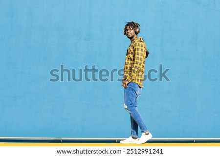 Similar – Image, Stock Photo Handsome Black Man Walking in Park and Listening to Earphones