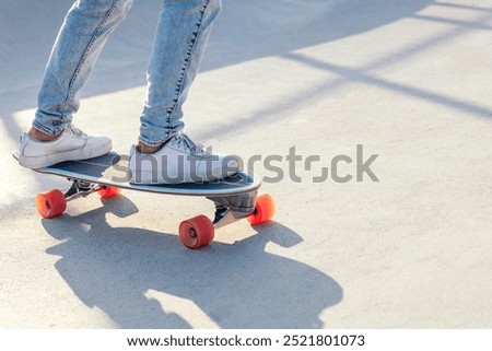 Similar – Image, Stock Photo Relaxed stylish skater riding skateboard along pavement