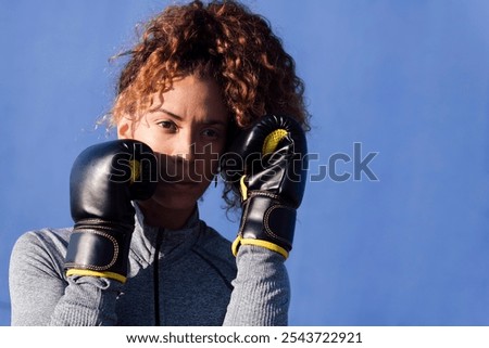Similar – Image, Stock Photo Serious sportswoman with boxer braids posing with crossed arms