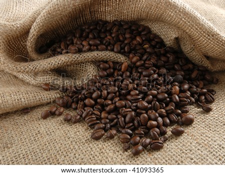 Espresso beans falling out of a canvas bag