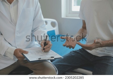 Doctor or physical therapist examines back pain and spinal area to give advice within the rehabilitation center. Foto stock © 