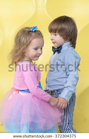 Side View Of A Little Boy And A Girl While Lying On The Beach And Back View Of Little Girl And Boy Holding Hands At Sunset Love
