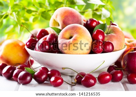 fresh fruits and berries on wooden table