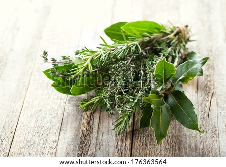 bunch of various herbs on wooden table