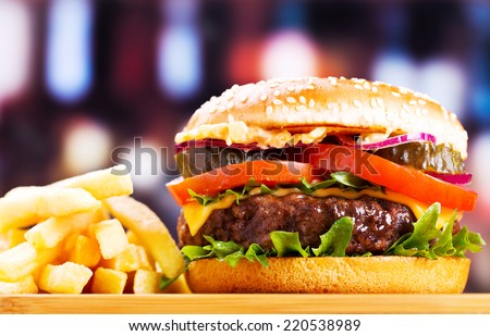 hamburger with fries on wooden table