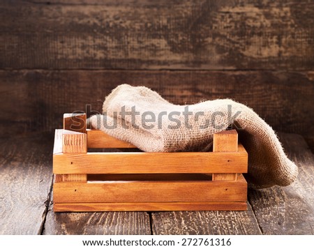 wooden box with sack on wooden background