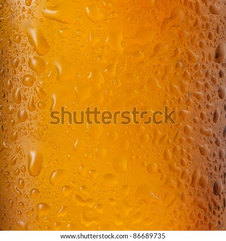 bottle of beer with water drops as background