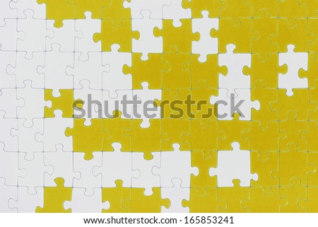 A puzzle is made up of puzzle pieces in two colors.
