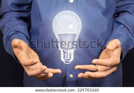 A lamp with LEDs floating above two hands.