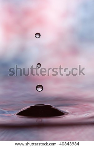 Colorful red, pink and blue water drop and splash