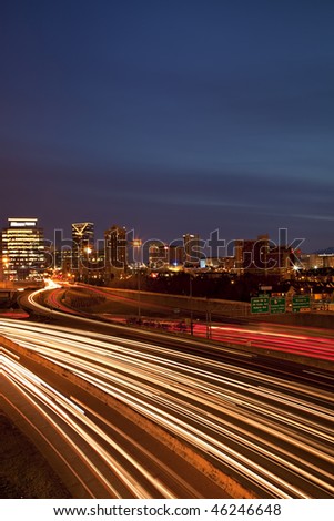 Beautiful sunrise or sunset in Atlanta, Georgia showing city skyline and light streaks from rush hour traffic