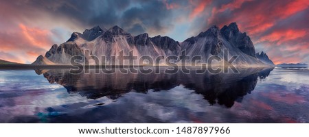 Vestrahorn mountaine on Stokksnes cape in Iceland during sunset with reflections. Amazing Iceland nature seascape. popular tourist attraction. Best famouse travel locations. Scenic Image of Iceland 商業照片 © 