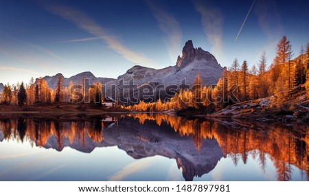 Photo of Majestic sunset of the mountains landscape. Wonderful Nature landscape during sunset. Beautiful colored trees over the Federa lake, glowing in sunlight. wonderful picturesque scene. color in nature