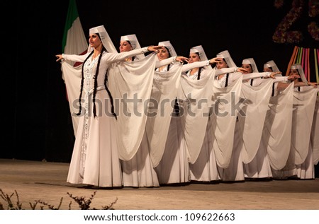 RUSSI, ITALY  - AUGUST 5: dancers of ensemble Khorumi from Georgia performs elegant traditional dance - georgian girls in typical dress at International folk festival on August 5, 2012 in Russi, RA, Italy