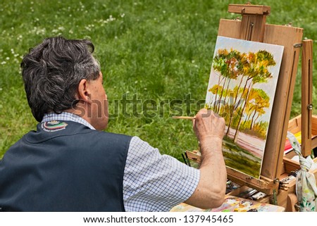 FOSSO GHIAIA, RAVENNA, ITALY - APRIL 28: painter at work painting the pine forest during the festival \