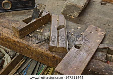 set of old planers on the carpenter\'s bench - ancient carpentry tools for woodworking