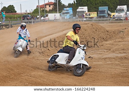 PEZZOLO DI RUSSI, RA, ITALY - JUNE 9: unidentified drivers riding old scooters Vespa on the motocross track during the motor festival \