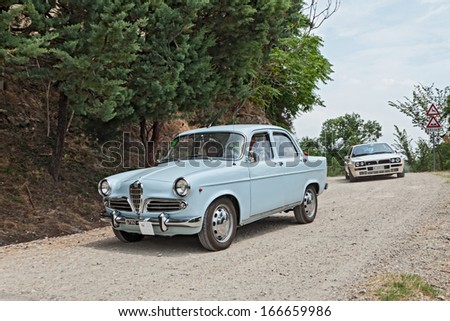 FOGNANO, RA, ITALY - JULY 7: unidentified crew on a vintage car Alfa Romeo Giulietta (1961) runs on a dirt road during the rally \