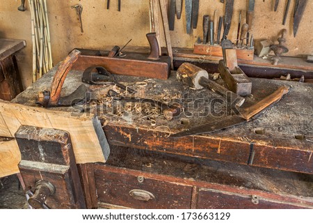 woodworking tools of antique carpentry - old bench with carpenter\'s equipment  - ancient carpentry craftsman workshop
