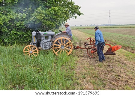 BASTIA,RA, ITALY - APRIL 27: unidentified men plow the field with an old tractor Landini Cv 25 during the country fair \