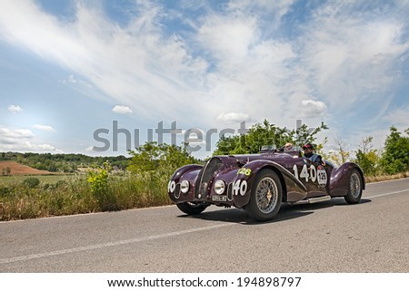 COLLE DI VAL D\'ELSA, ITALY - MAY 17: unidentified crew on a vintage sport car Alfa Romeo 6C 2300 B MM spider Touring (1938) runs in race Mille Miglia, on May 17, 2014 in Colle di Val d\'Elsa, Italy