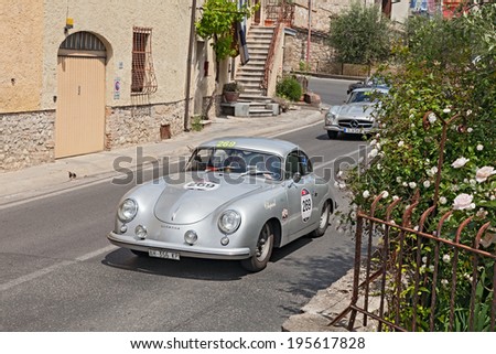 COLLE DI VAL D\'ELSA, SI, ITALY - MAY 17: female crew on a vintage sport car Porsche 356 1500 (1953) runs in historical rally Mille Miglia, on May 17, 2014 in Colle di Val d\'Elsa, SI, Italy