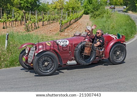 COLLE DI VAL D\'ELSA, SI, ITALY - MAY 17: the crew Frans and Renee Van Haren on ancient racing car Alfa Romeo 8C 2900 A (1936) in rally Mille Miglia, on May 17, 2014 in Colle di Val d\'Elsa, SI, Italy