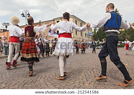 RUSSI, RA, ITALY - AUGUST 3: Folklore ensemble Saint George\'s Church, from Belgrade, Serbia, performs circle dance at International Folklore Festival of Russi, on August 3, 2014 in Russi, RA, Italy