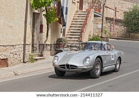 COLLE DI VAL D\'ELSA, SI, ITALY - MAY 17: the crew De Rosa Confalonieri on a concept car Alfa Romeo 2000 Sportiva (1954) in rally Mille Miglia, on May 17, 2014 in Colle di Val d\'Elsa, Tuscany, Italy