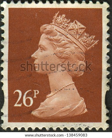 UK-CIRCA 1990: A stamp printed in UK shows image of Elizabeth II is the constitutional monarch of 16 sovereign states known as the Commonwealth realms, in Drab, circa 1990.