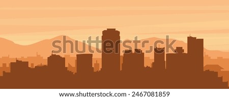 Brown panoramic poster of the city skyline with misty background buildings, sunrise, clouds and mountains of PHOENIX, UNITED STATES