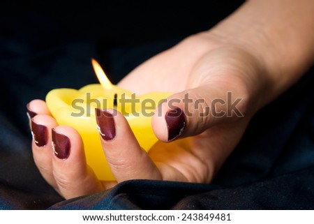 Woman manicure arranged with candle