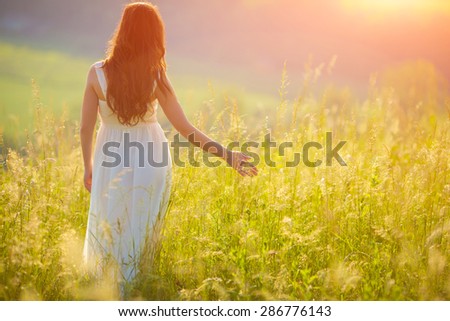 Bride Enjoying Nature. Free Happy Woman. Lit evening sun. Freedom concept.