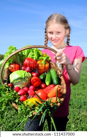 little girl with basket of vegetables