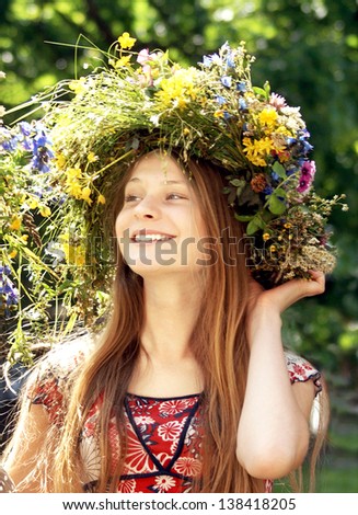 Portrait of a beautiful young girl with flower diadem