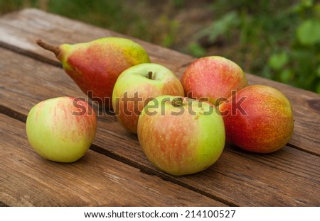 apples and pears on wooden table
