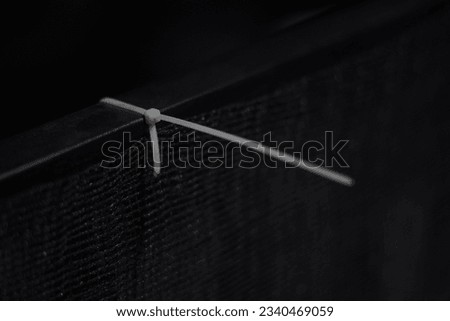 Similar – Image, Stock Photo Knotted remainder of an orange fluttering band on a rusty iron bar of a fence in front of a brown background