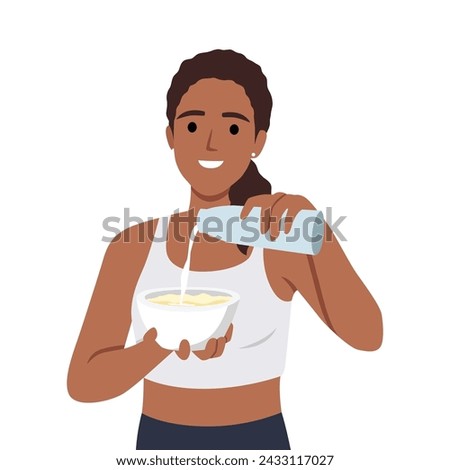 Young woman preparing healthy breakfast adding milk to plate after morning fitness or sports. 
