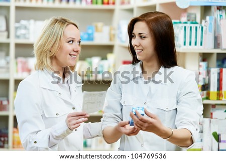 two pharmacist chemist women discussing medicine and prescription in pharmacy drugstore