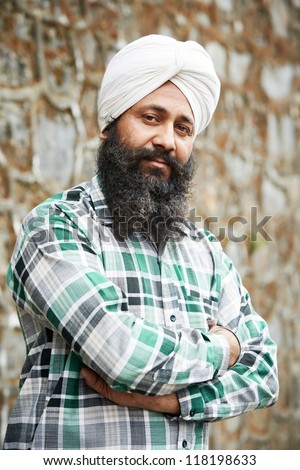 Portrait of authentic Indian sikh man in turban with bushy beard