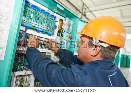electrician at work checking wire with drawing inspecting high voltage power electric line distribution fuseboard