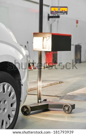 automobile car inspection headlight checkup at repair service station
