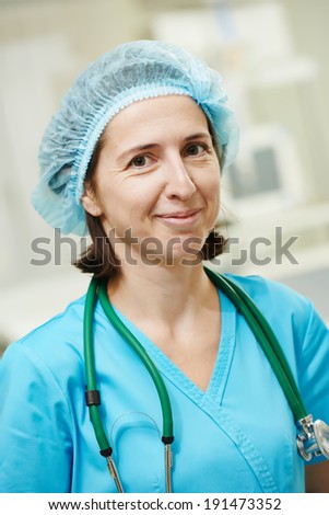 Portrait of female surgeon in uniform in surgery operation room at clinic