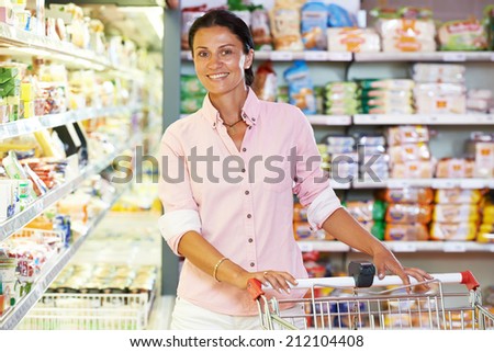 woman during shopping at supermarket with cart trolley