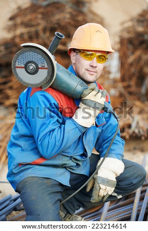 Construction builder worker portrait with grinder machine for cutting metal reinforcement rebar rods at building site